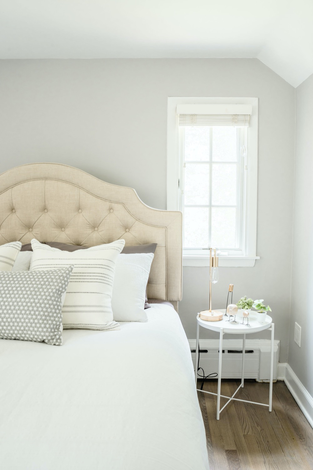 white bed and side table